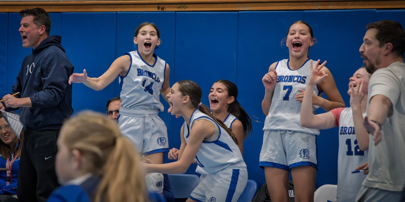The BYBA girls bench cheering on their teammates