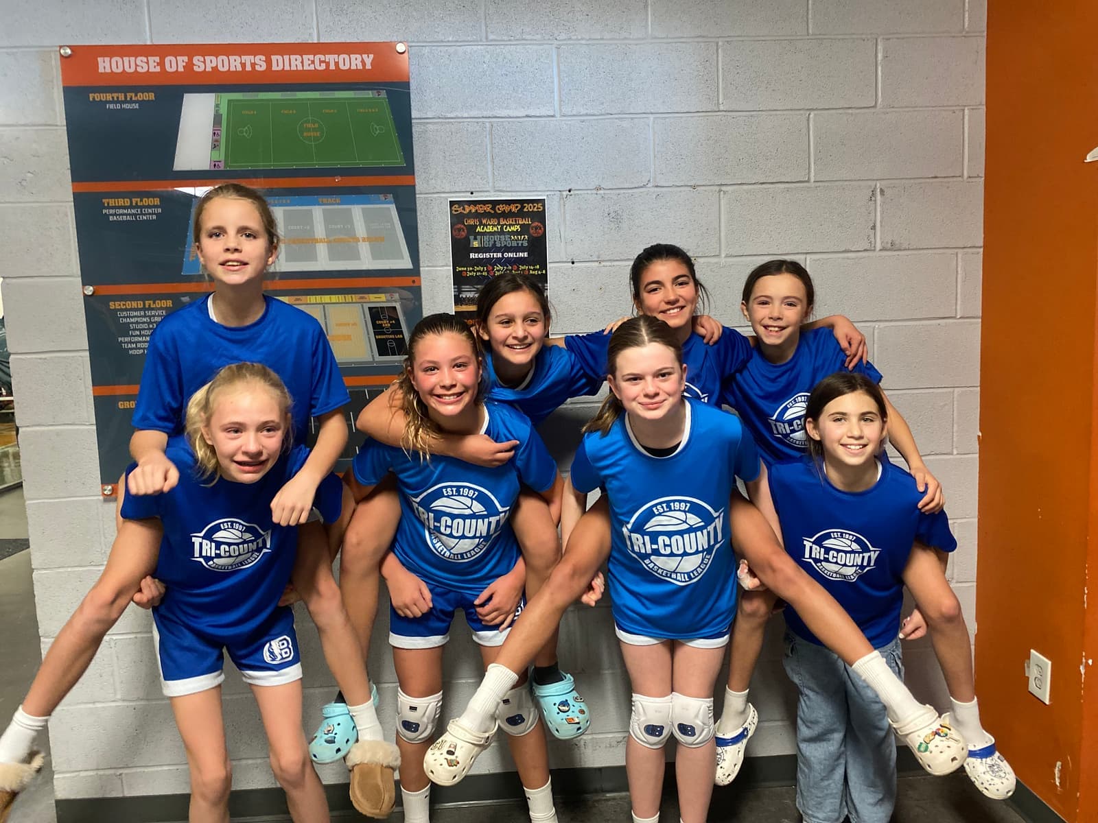 A BYBA girls team posing together at a tournament