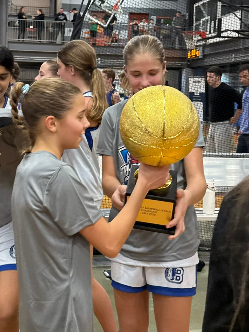 BYBA girls carrying the championship trophy