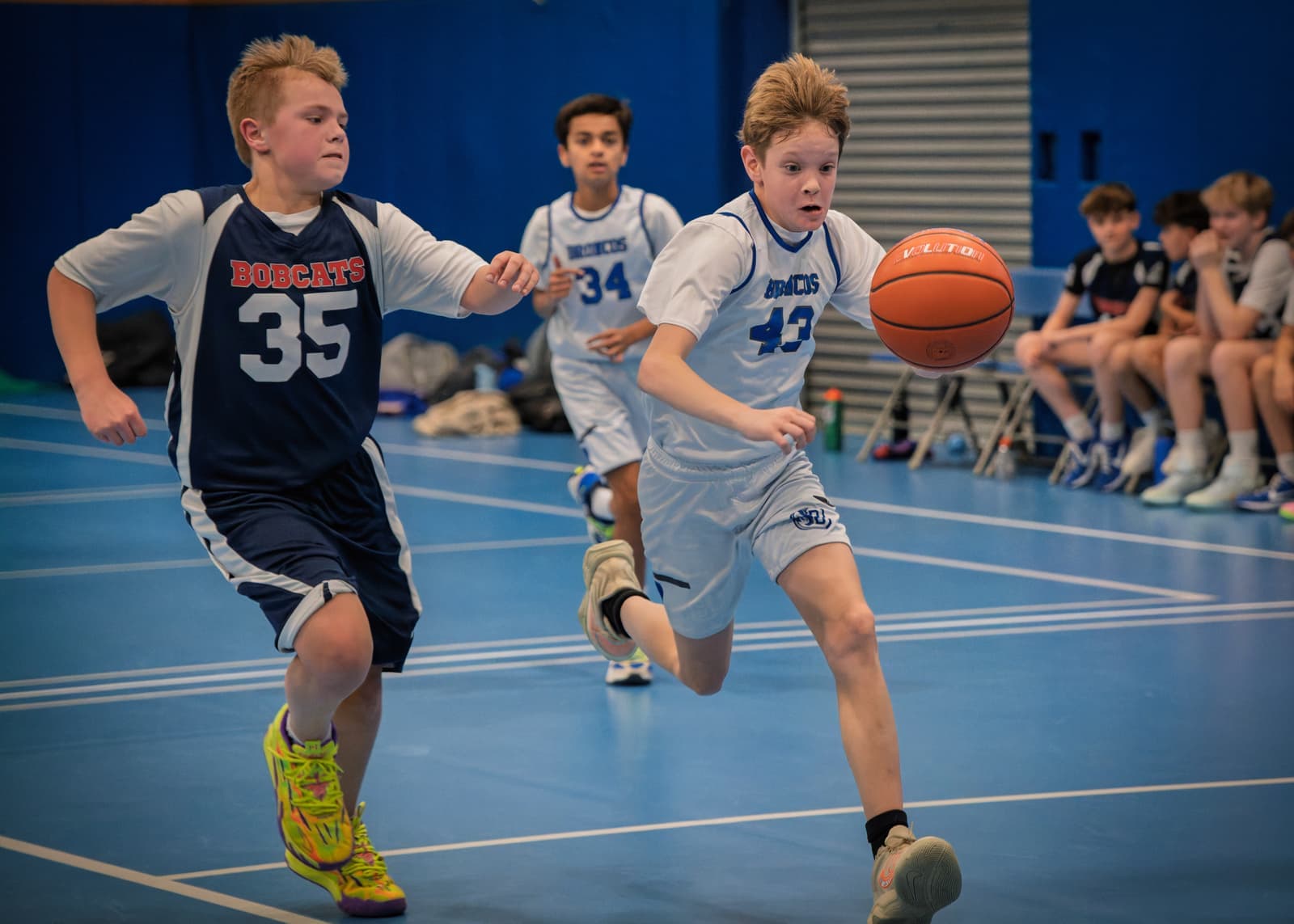 A Bronco chasing down a loose ball