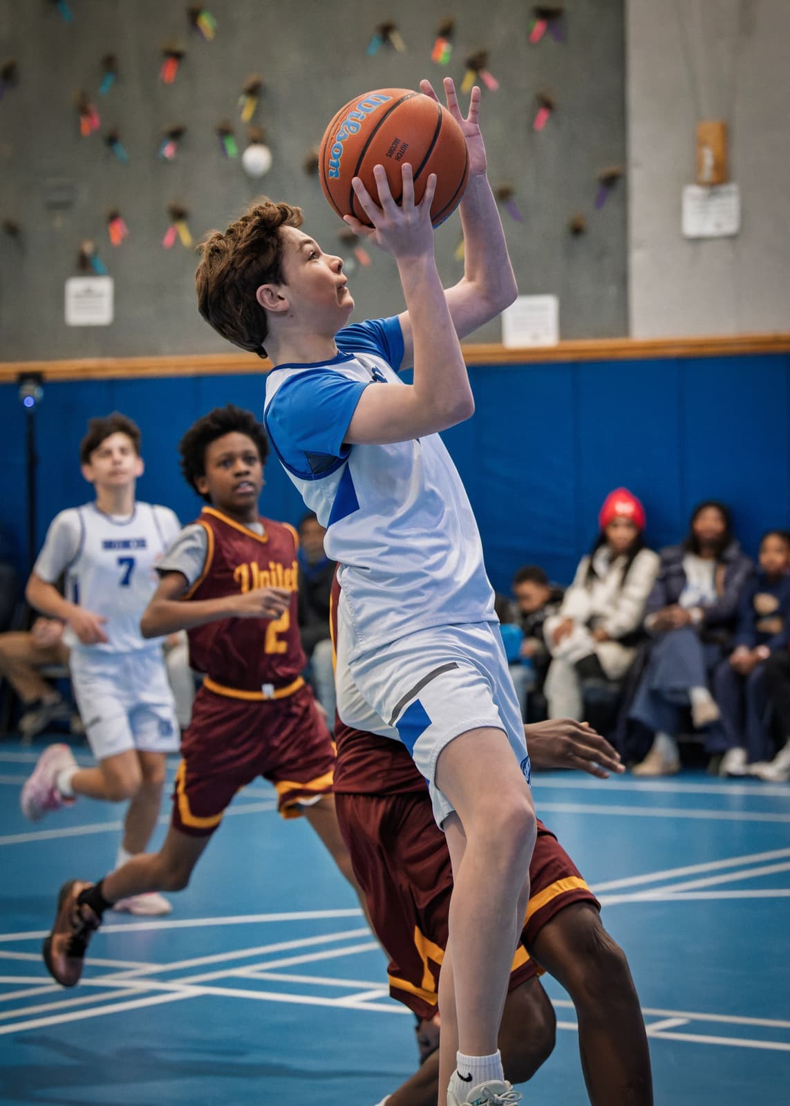 A Bronxville player rising for a layup in a travel game