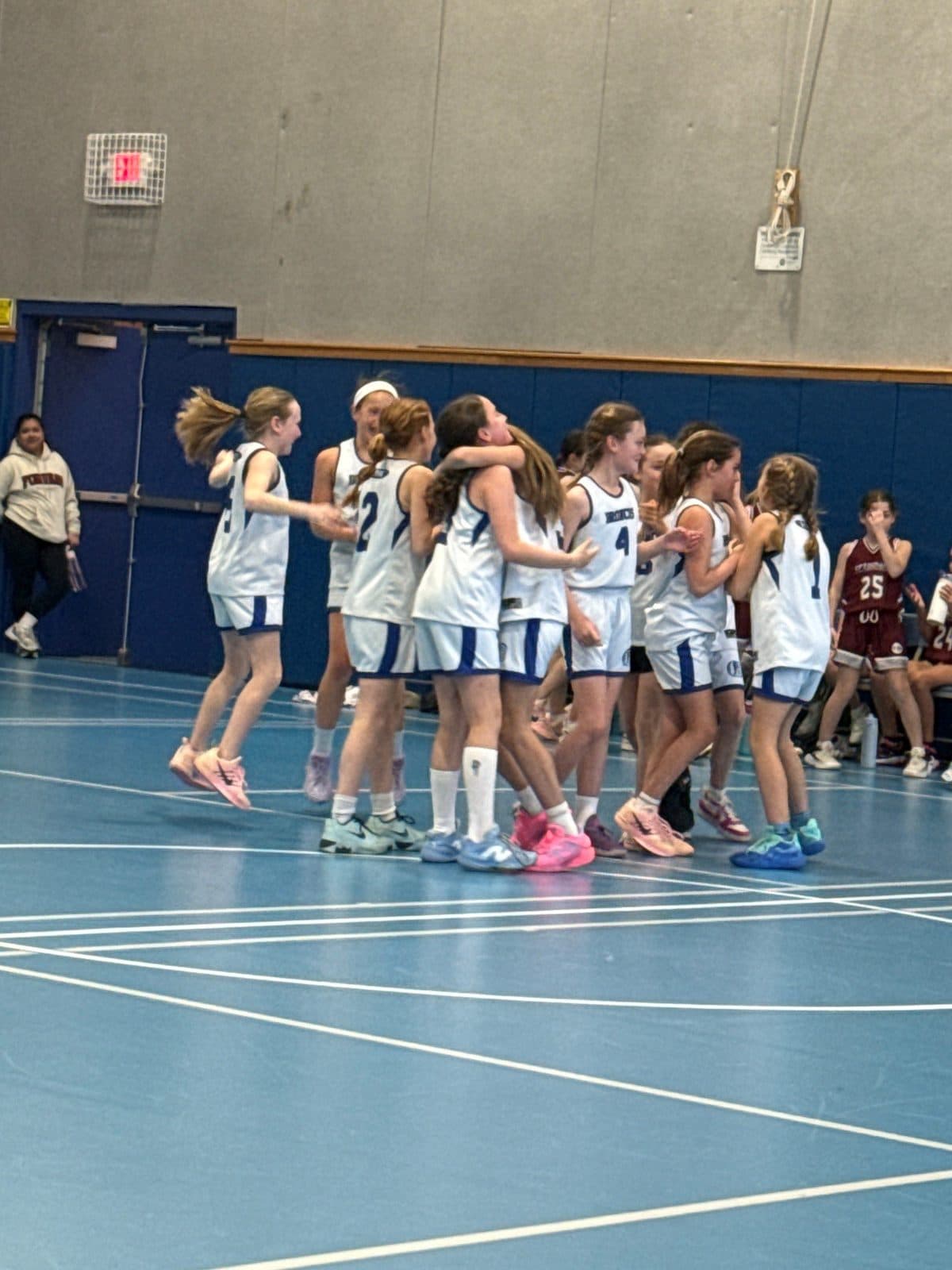 A BYBA girls team celebrating together after a game
